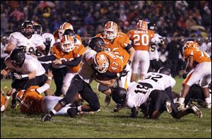 Sylvania Southview High School player Jay Fisher, 47, bulls his way into the endzone against Perrysburg High School player Tyler Gordon, 12, during the third quarter at Sylvania Northview, Friday, Sept. 30, 2011.