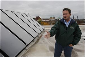 David Leahy, director of sales for Dovetail Solar and Wind, explains how the 48 solar panels on top of Madonna Homes in Toledo, Ohio provide green energy to the apartment complex.
