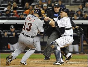 New York Yankees catcher Russell Martin tags out Detroit Tigers' Alex Avila (13) trying to score at home plate in the fifth inning during the continuation of Game 1 of baseball's American League division series on Saturday, at Yankee Stadium in New York.