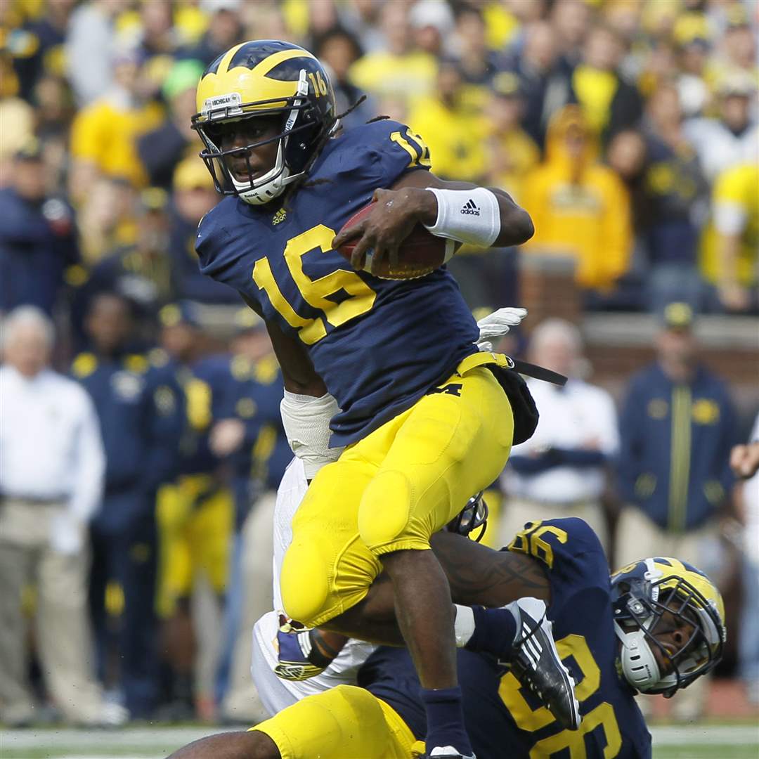 Michigan-s-Denard-Robinson-gets-a-block-from-Koger