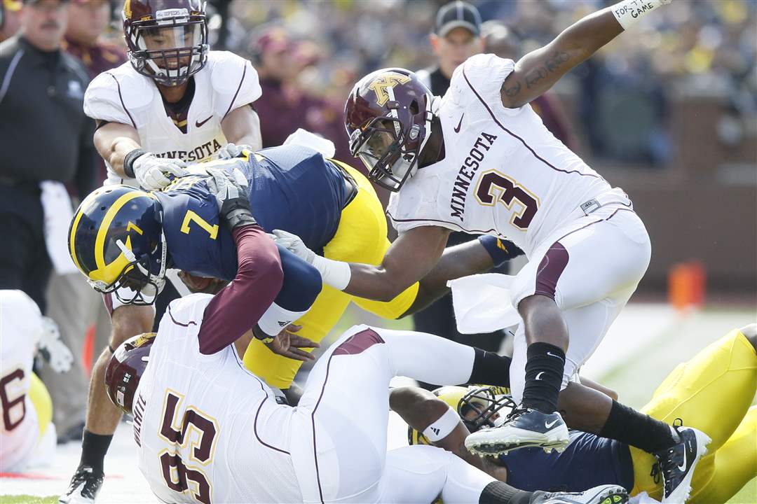 Michigan-s-Devin-Gardner-is-dragged-toward-the-sidelines