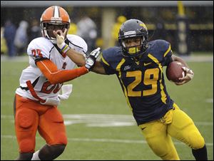 West Virginia's Dustin Garrison pushes away Bowling Green's Aaron Foster during the quarter of an NCAA college football game Saturday, Oct. 1, 2011, in Morgantown, W.Va. (AP Photo/Tyler Evert)