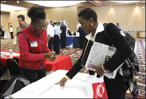 Siccorah (cq) Whitlow, left, Human Resources Manager at Lowe's speaks with Beverly Barnhill, right, from Toledo, during a job fair for job seekers 50 years old and above at The Pinnacle in Maumee on October 4, 2011.