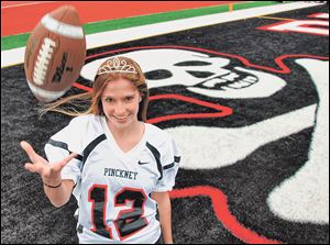 In this Oct. 1, 2011, photo Brianna Amat poses at Pinckney Community High School in Pinckney, Mich. Shortly after being named homecoming queen, Brianna kicked the field goal that proved to be the difference as Pinckneybeat Grand Blanc 9-7 on Friday, Sept. 30.