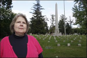 Donna Christian, who has more than 30 years' experience as a librarian in the local history and genealogy department, Toledo-Lucas County Public Library, is to be one of the tour guides. The cemetery's Civil War monument is in the background.
