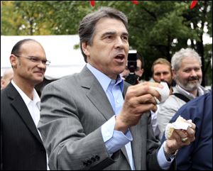 Republican presidential candidate Texas Gov. Rick Perry eats some local samples during a campaign stop a the Chili Festival last week in Manchester, N.H.