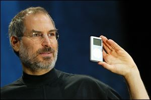 Jobs holds a new mini iPod at Macworld Jan. 6, 2004.