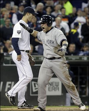 New York Yankees' Russell Martin reacts after scoring on a Derek Jeter double to center field during the third inning of Game 4 of baseball's American League division series against the Detroit Tigers on Tuesday, Oct. 4, 2011, in Detroit.