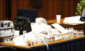 Drugs found in the home of pop star Michael Jackson by Los Angeles County coroner investigator Elissa Fleak sit on the prosecution's table after being introduced as evidence during Dr. Conrad Murray's trial in the death of Jackson in Los Angeles, Thursday.