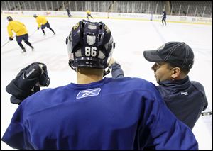 Toledo Walleye player Evan Rankin, 86, listens to head coach Nick Vitucci during practice, Wednesday, October 5, 2011.