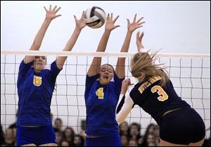 St. Ursula's Cassidy Croci, 6, and Erin Williams, 4, block the shot of Notre Dame Academy's Morgan Fioritto in the first game.