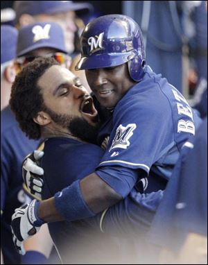 Milwaukee Brewers' Prince Fielder lifts Yuniesky Betancourt after Betancourt hit a two-run home run during the fifth inning of Game 1 of baseball's National League championship series against the St. Louis Cardinals Sunday in Milwaukee. 