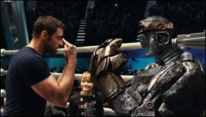 Hugh Jackman, left, and Dakota Goyo face off in a scene from 