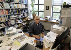 Christopher Sims, 68, a professor, sits in his office at Princeton University .