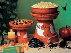Embellish your Halloween party buffet by transforming ordinary terra cotta pots into spooky party servers.