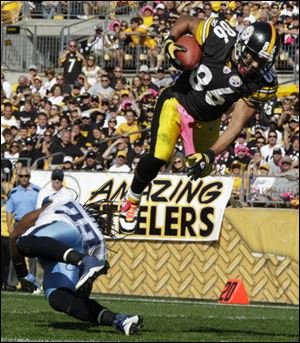 Pittsburgh receiver Hines Ward heads to the end zone over Tennessee safety Michael Griffin, scoring a touchdown during the third quarter of the Steelers' 38-17 victory Sunday. 