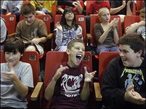 Left to right fifth graders Deven Miller, Drew Bertz, and Zack Prater, cheer Rossford School District teacher Karen Gunn.