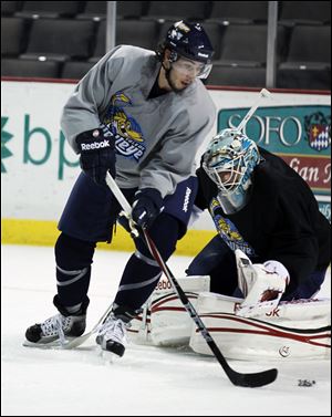 Mike Pelech tries to score on goaltender Carter Hutton during a Walleye practice. Pelech played last season for Ontario in the ECHL where he had 127 penalty minutes.
