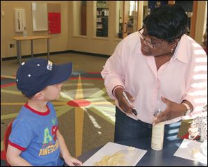Dawson Call ,4, of Whiteford,Mich., talks with the Bedfrod Branch Library Children's Librarian Karen Moore.