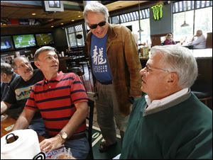the blade/dave zapotoskyChuck Helburn of Sylvania Township, standing, joins Joel Weinberg of Monclova Township, left, Ron Black of Perrysburg, and Jerry Cooper of Sylvania Township at a Sylvania restaurant. The Romeo -- Retired Old Men Eating Out -- group has been meeting about a dozen years.