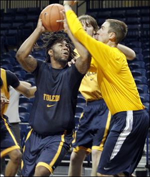 Reese Holliday goes up to the basket as UT assistant coach Jason Kalsow defends in practice. Holliday is one of three returners from last year’s Toledo team, which finished 4-28.