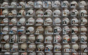 Some of the more than 4,000 autographed baseballs are shown at Dennis Schrader's home in Odessa, Fla.
