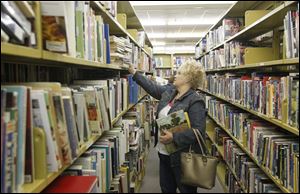 Wanda Davenport of East Toledo mines the shelves at the book sale. 