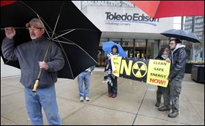 Attorney Terry Lodge and other protestors demonstrate outside the Toledo Edison building at Levis Square in downtown.  They were there to bring attention to a resolution they are proposing that would speak to the need for independent inspection at the Davis-Besse nuclear power plant, as well as protection of public health and public safety and alternative energy.