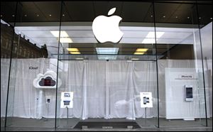 White curtains hang as employees inside the Lincoln Park Apple store in Chicago, gather to watch a video feed from the California memorial service for founder Steve Jobs Wednesday.
