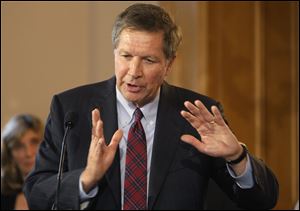 Ohio Gov. John Kasich answers questions during a news conference after he signed an executive order on dangerous exotic pets.