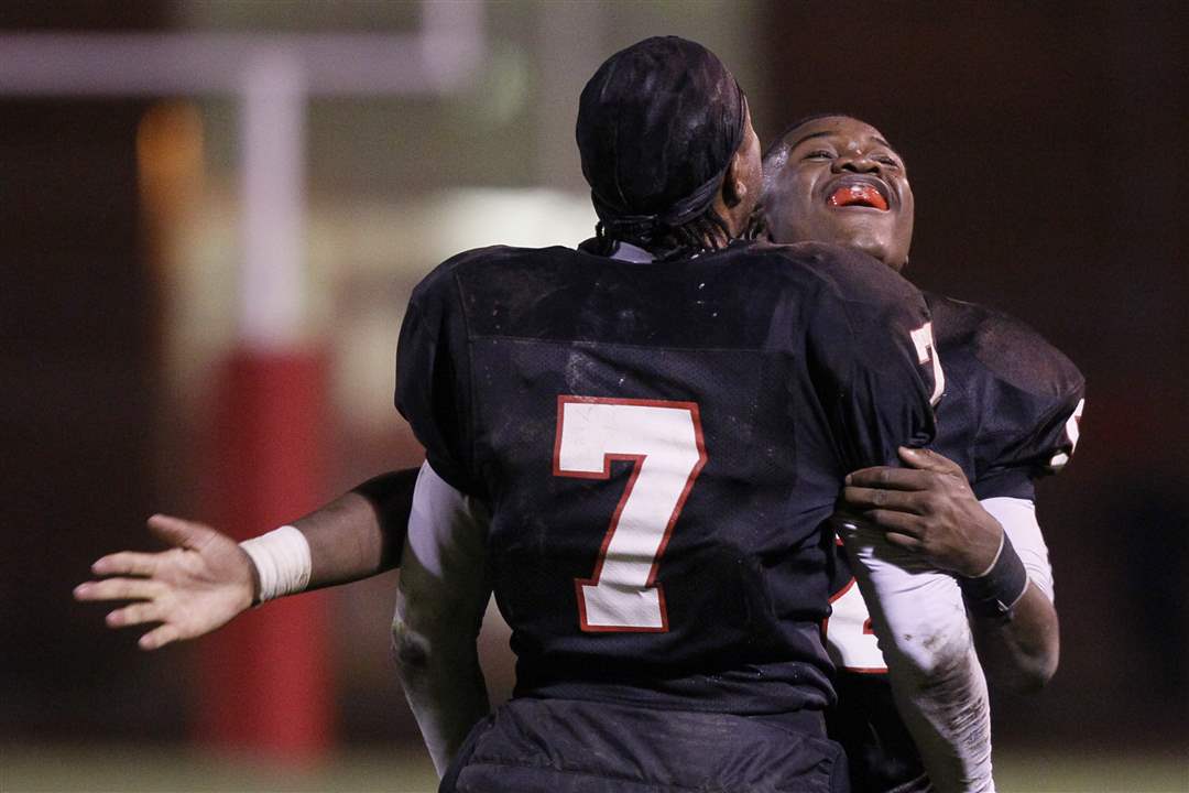 Rogers-player-Juan-Harris-and-teammate-celebrate-Friday-s-victory