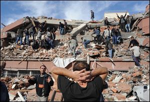 People try to save people trapped  under debris in Tabanli village near the city of Van after a powerful earthquake struck eastern Turkey Sunday.