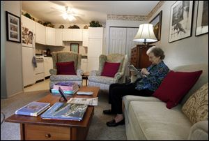 Jane Merrill relaxes in her apartment in the home of her son, William Merrill, in Carmel, Ind. The Merrills renovated their two-car garage into an apartment for Ms. Merrill, who at the time was 81. Apartments such as these are becoming increasingly popular. 