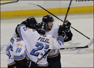Toledo's Evan rankin, left, Michael Pelech, and Justin Pender congradulate Phil Rauch, in middle, after his third-period goal.