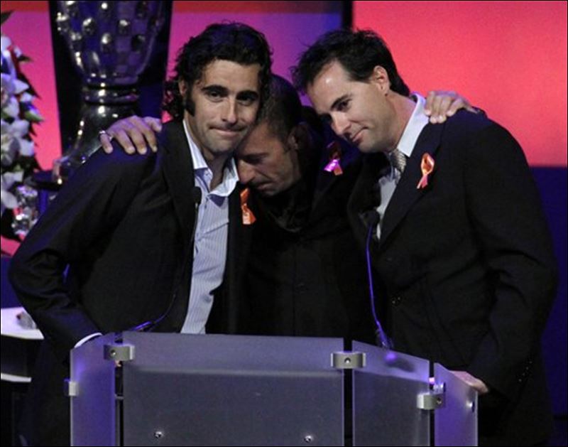 Former teammates Dario Franchitti left Tony Kanaan and Bryan Herta hug 