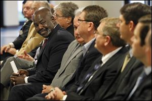 Mayor Mike Bell, left, looks over at Chris Marshall, BX Solutions' chief executive officer after he was recognized by Gov. John Kasich.