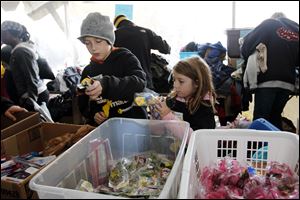 Young mayors Jimmy Davis, 11, left, and his sister Alisa Davis, 7, both of Oregon, prepare to give out toys to children in the clothing tent. Toledo's Tent City, an annual weekend to bring attention to the homeless, in Toledo, Ohio on October 29, 2011.  For the first time, the mayors of Toledo's Tent City are a family. The four-person Davis family of Oregon, despite both parents working, were homeless for a period in 2007.