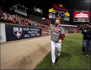 The Cardinals' Chris Carpenter celebrates with fans Friday after Game 7 of baseball's World Series against the Texas Rangers in St. Louis. The Cardinals won 6-2 to take the series.