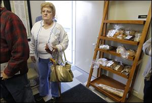 Kathleen Kress of Perrysburg, jobless since 2008, waits for food at Perrysburg’s Grace United Methodist Church. 