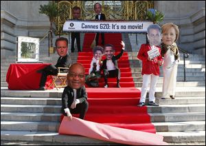 Oxfam activists wear masks of, from left, British Prime Minister David Cameron, South African President Jacob Zuma, Brazilian President Dilma Rousseff  United States President Barack Obama, French President Nicolas Sarkozy, and German Chancellor Angela Merkel, with at the top Russian President Dmitry Medvedev and Mexican President Felipe Calderon, during a protest Monday in Paris ahead of the G20 meeting.