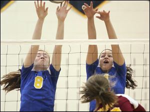 St. Ursula's Lauran Graves, left, and Erin Williams, right, block an attempt by Avon Lake's Christine Bohan in Wednesday's D-I regional semifinal to help the Arrows win.