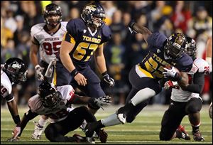 Toledo running back David Fluellen (22) runs the ball against Northern Illinois during the second quarter of an NCAA college football game at the Glass Bowl in Toledo.