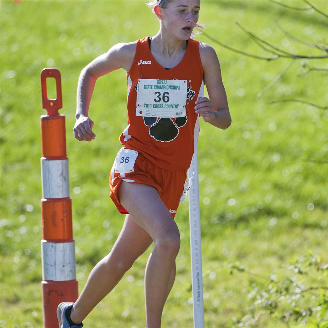 Liberty-Center-s-Brittany-Atkinson-races-past-a-flag-near-the-2-mile-mark