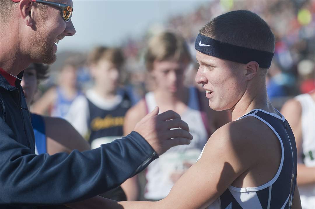 Napoleon-runner-Steve-Weaver-right-is-greeted-by-assistant-coach-Jeff-Ressler