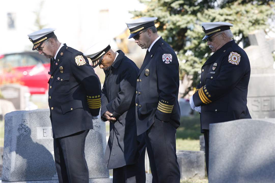 Fire-department-officials-bow-thier-heads-Charolette-Adair