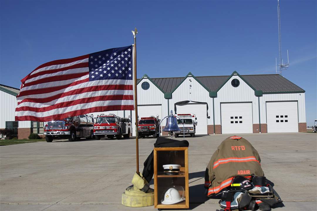 Flag-and-firefighters-gear-outside-fire-station