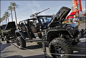 The 2011 'Call of Duty: Black Ops' Jeep Wrangler Unlimited was modified by a Texas company. Among the accouterments are a 5.7-liter Hemi V8 engine and machine-gun mounts on the roof and sides.