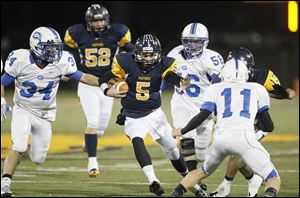 Whitmer quarterback Tyler Palka cuts between Anthony Wayne's Hunter Lonseth, left, Todd Bernhard, and Josh Schwerer in last night's Division I playoff game at Whitmer.