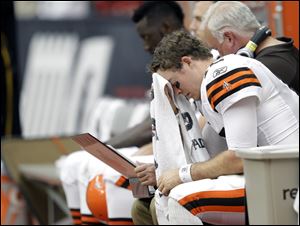 A dejected Colt McCoy tries to collect his thoughts after another unsuccessful series on Sunday.