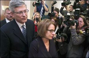 Ex-Penn State Athletic Director Tim Curley, left, and his wife, Melinda, enter the courtroom for his arraignment on charges of perjury and failure to report abuse.